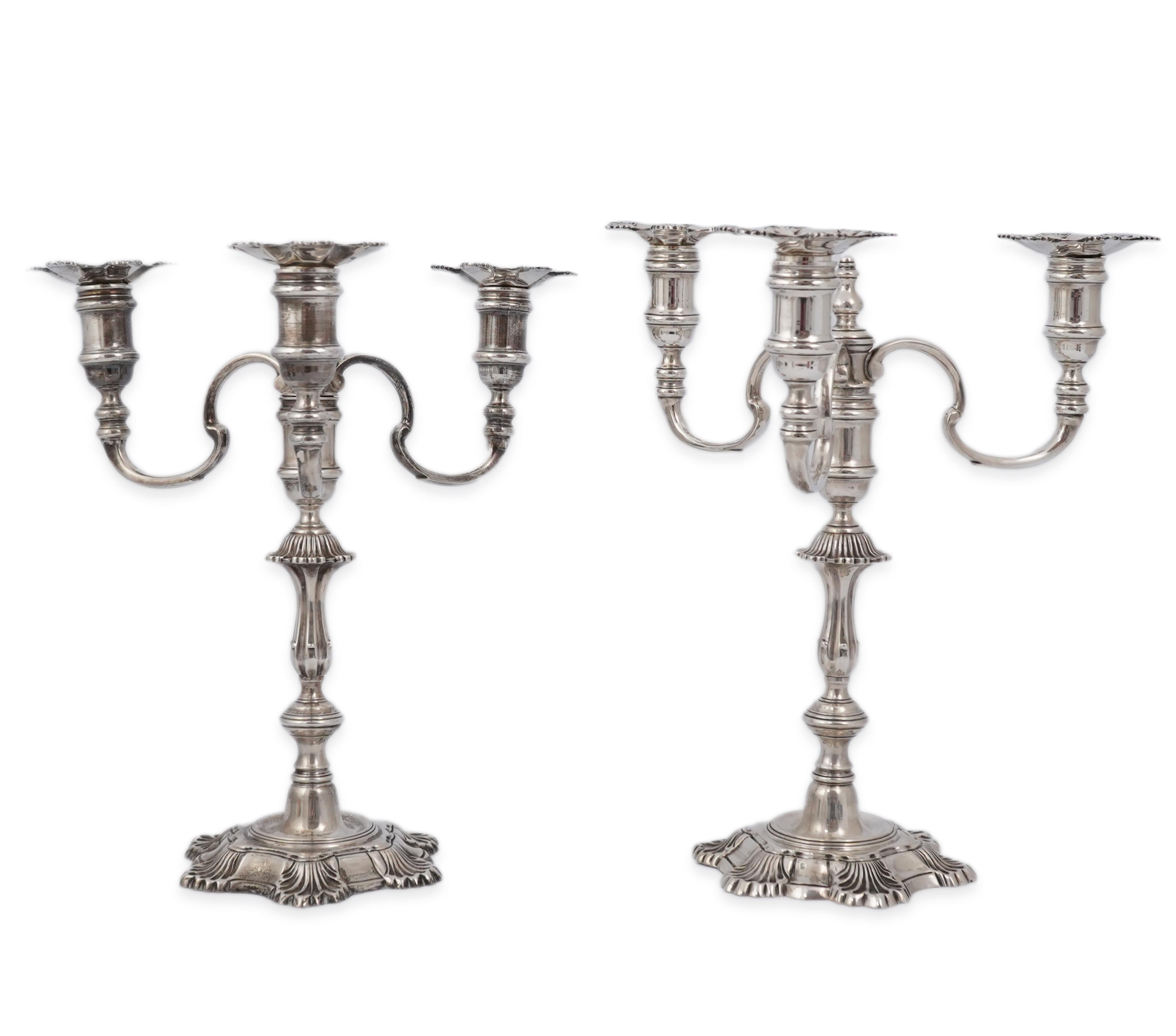 A pair of Elizabeth II cast silver three branch, three light candelabra, by J.B. Chatterley & Sons Ltd